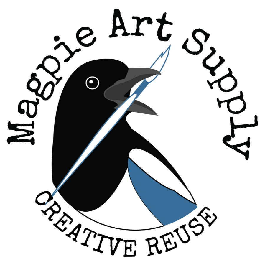 Magpie Art Supply logo is a magpie's black, white, and blue head and upper body looking to the right and holding a paint brush in its open beak